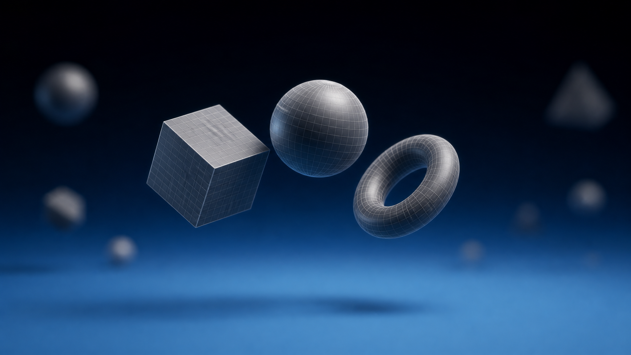 3D geometric shapes — cube, sphere, and torus